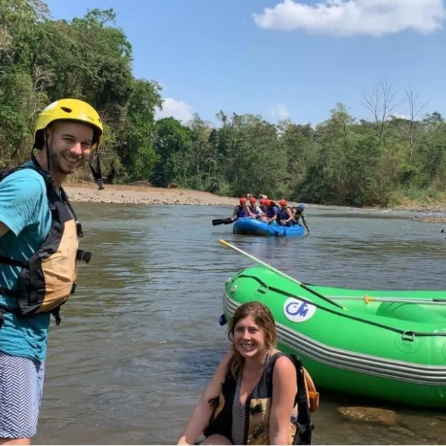 people on shore by plastic inflatable rafts