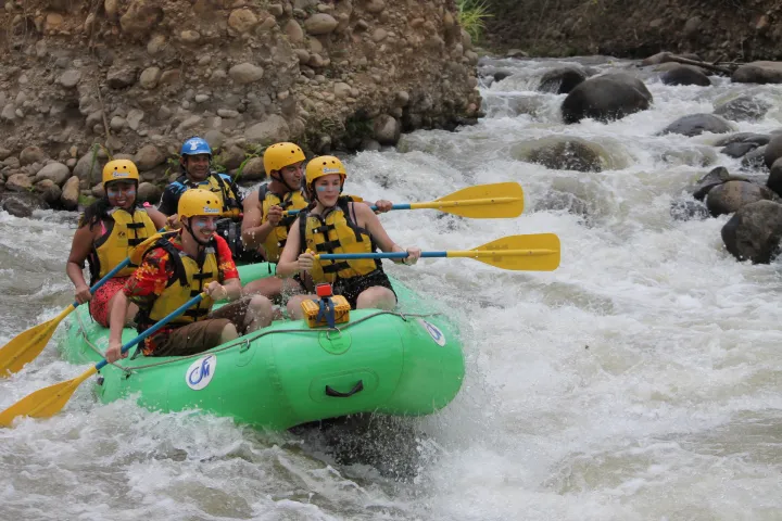 a group of people on a raft in the water
