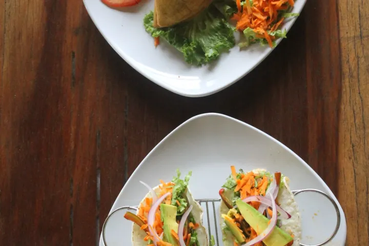 a plate of food sitting on top of a wooden table