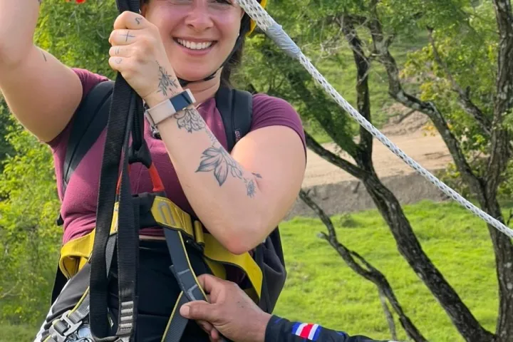 a woman wearing a helmet holding a baseball bat