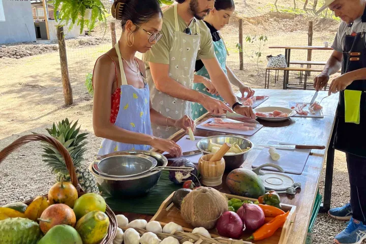 a group of people sitting at a fruit stand